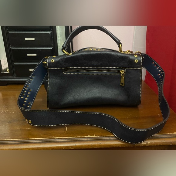 Black leather cross body purse with orange colored medallion on front. - Picture 13 of 14